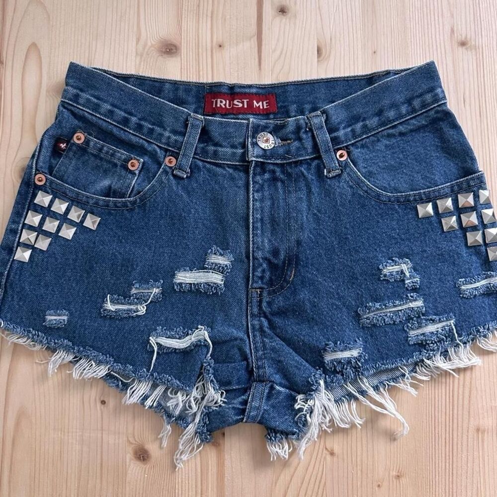 Y2K Trust Me denim shorts with silver studs and distressed details.